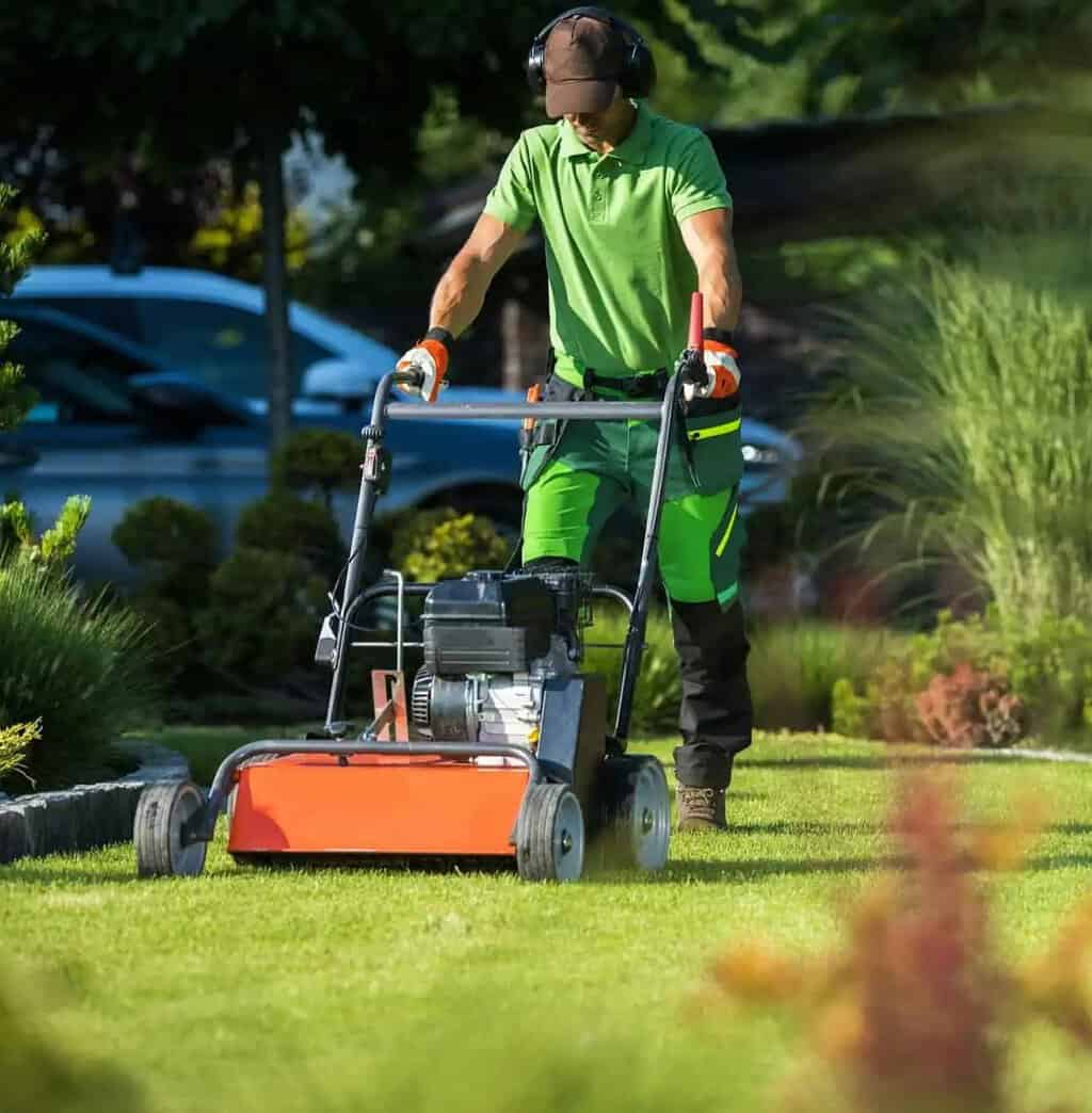 landscaper-with-scarifier-machine-taking-care-of-a-lawn-1